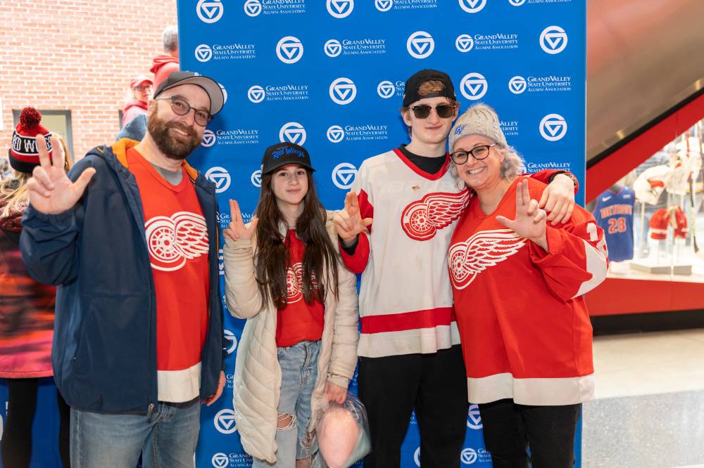 Susan Proctor standing with her family at the Red Wings game.